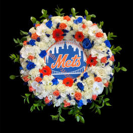 Circular floral wreath around a Mets logo sign