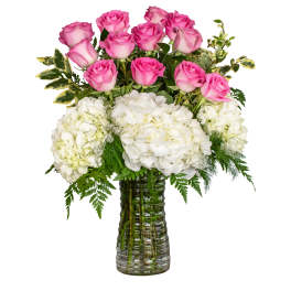 Pink roses and white hydrangeas in a glass vase