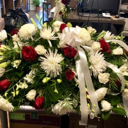 Large red and white floral spray with ribbon