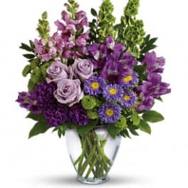 Purple mixed bouquet in a clear glass vase