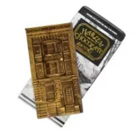 Two packaged chocolate bars, one gold-wrapped and one black-and-silver wrapped