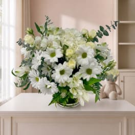 White daisy and rose bouquet in a low glass vase