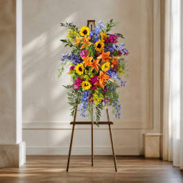 Tall colorful floral arrangement on a wooden easel