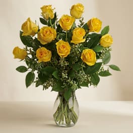 Yellow roses arranged in a clear glass vase