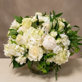 Cream and white flower arrangement in a glass bowl vase