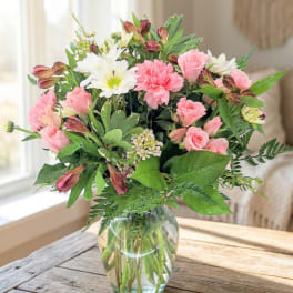 Pink and white mixed bouquet in a clear glass vase