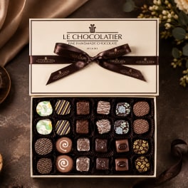 Box of assorted chocolates tied with a brown ribbon