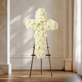 White floral cross on a stand