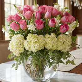 Pink roses and white hydrangeas in a clear glass vase