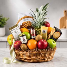 Gift basket with fruit, snacks, and a pineapple centerpiece