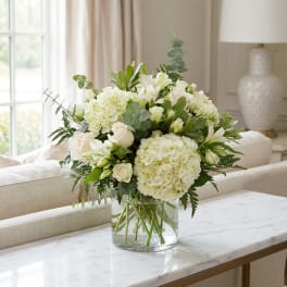 White floral arrangement in a clear glass vase