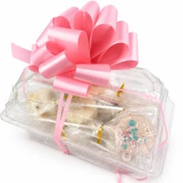 Gift box with pink ribbon and assorted sweets in clear plastic packaging