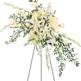 White floral arrangement on a tall stand with trailing greenery