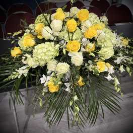 Yellow and white rose arrangement with hydrangeas and greenery