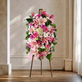 Pink and white floral standing arrangement on an easel