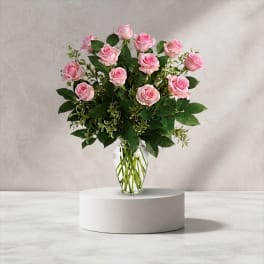 Pink roses arranged in a clear glass vase