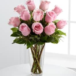 Pink roses arranged in a clear glass vase