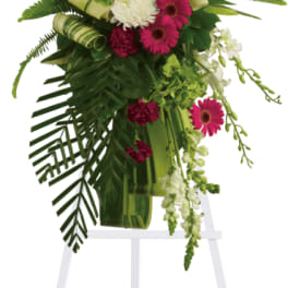 Tall floral standing spray with pink and white flowers on an easel