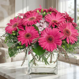 Pink gerbera daisy bouquet in a clear glass vase