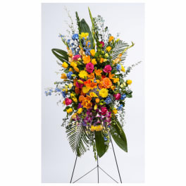 Tall standing spray of mixed colorful flowers on an easel