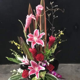 Tall tropical bouquet with pink lilies and red roses