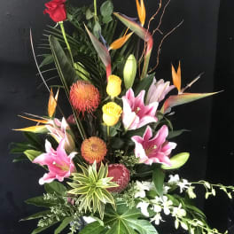 Tall tropical bouquet with pink lilies, red roses, and bird-of-paradise