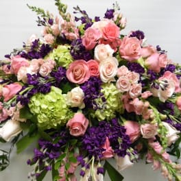 Large bouquet of pink and white roses with purple flowers