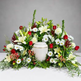 Sympathy floral arrangement with white urn and red roses