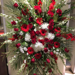 Large red and white floral standing spray with roses and gerbera daisies
