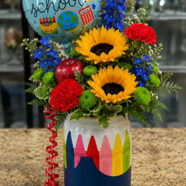 Sunflowers and carnations in a decorated jar with a back-to-school balloon