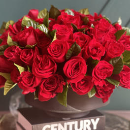 Large bouquet of red roses in a dark vase