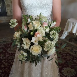Bride holding a white and blush wedding bouquet