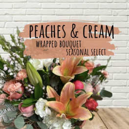 Peach and cream wrapped bouquet with lilies and roses