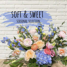 Mixed bouquet of pastel flowers with blue hydrangeas and pink roses