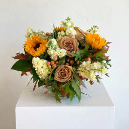Bouquet with sunflowers, tan roses, and pale cream blooms
