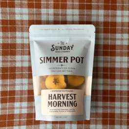 Package of harvest simmer pot potpourri on a plaid cloth