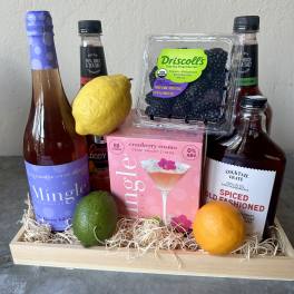 Gift tray with cocktail mixers, berries, and citrus fruit