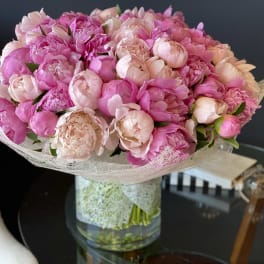 Pink peony bouquet in a clear glass vase
