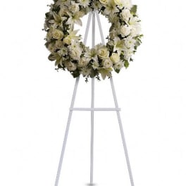 White floral wreath on a standing easel