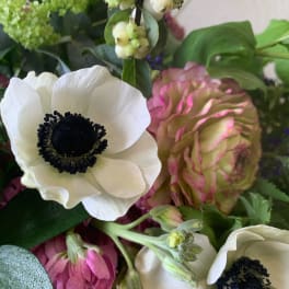 Close-up bouquet with white and pink anemones and mixed greenery