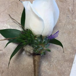 White calla lily boutonniere with succulent and green accents