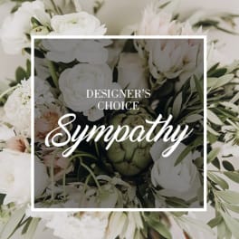 White sympathy bouquet with pale pink flowers and greenery