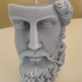 Gray sculpted candle shaped like a bearded face