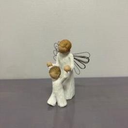 Two small angel figurines in white robes with wire wings