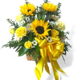 Yellow sunflowers and roses in a basket with a gold bow