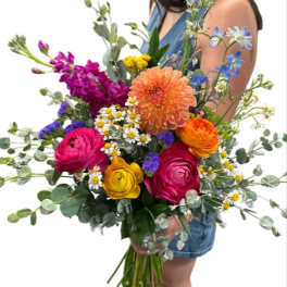 Colorful mixed bouquet with dahlias, ranunculus, and small daisies
