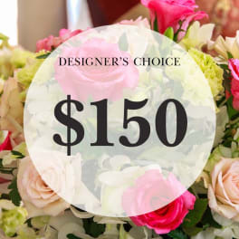Pink and white rose bouquet with a $150 designer's choice sign
