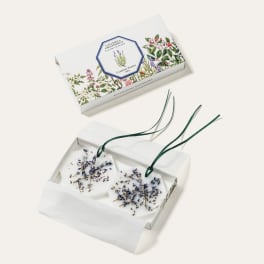 Two floral wax sachets in a gift box with lavender sprigs