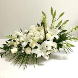 White lily and rose floral arrangement with greenery