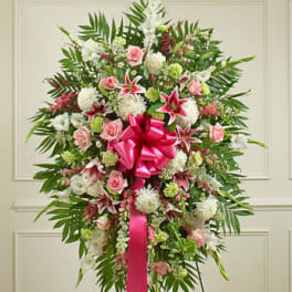 Standing floral spray with pink and white flowers and a bright pink ribbon